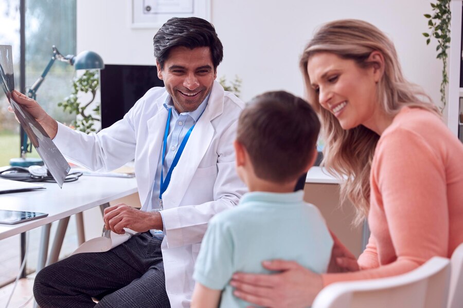 doctor-gp-white-coat-meeting-mother-son-appointment-office_562859-3409