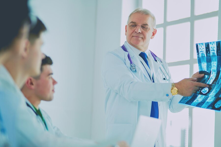 medical-team-sitting-discussing-table_358354-1977