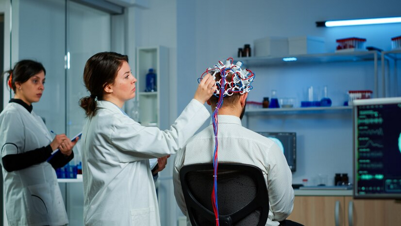 Screenshot 2024-10-09 at 11-09-58 Free Photo Back view of man patient wearing performant brainwave scanning headset sitting in neurological research laboratory while medical researcher adjusting it examining nervous system typi[...]