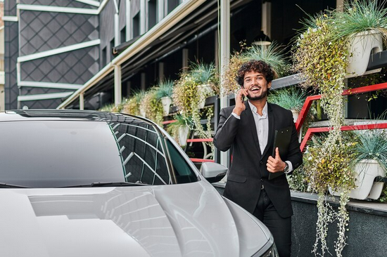 Screenshot 2024-10-26 at 12-07-30 Free Photo A businessman walks past his car