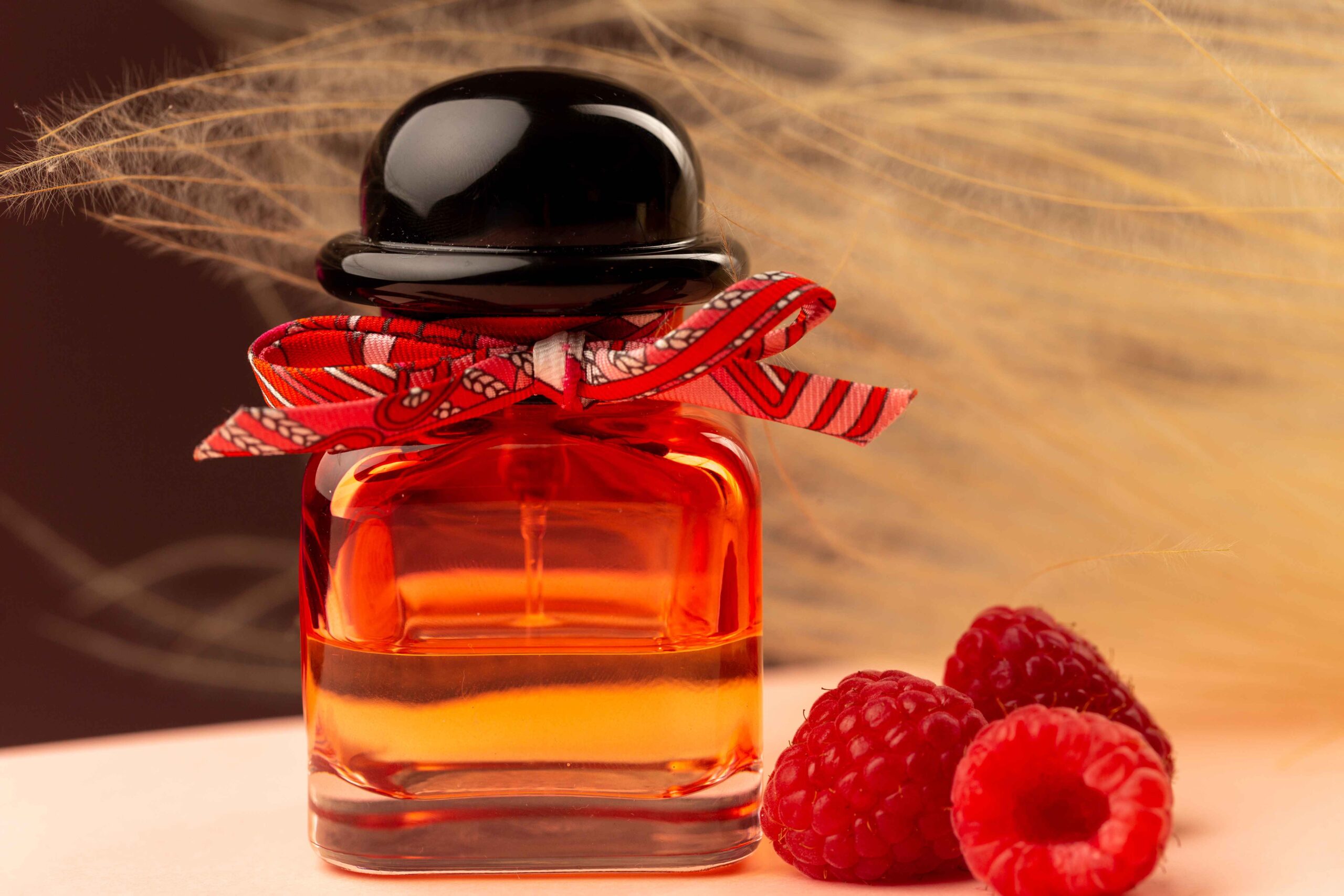 front-close-view-raspberry-smelling-perfume-inside-flask-purple-surface_11zon