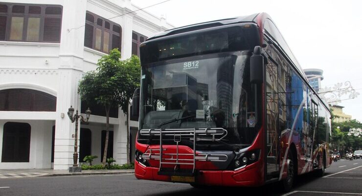 bus-driving-down-street-bus-facilities-general-public_12091-474