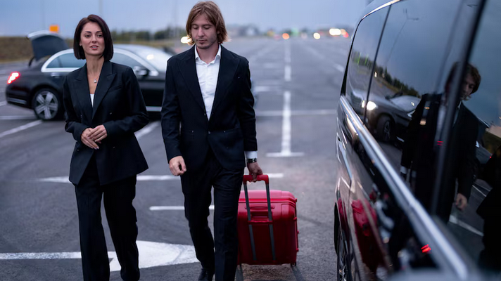 Screenshot 2024-12-14 at 13-30-37 Premium Photo Business couple walking with a suitcase on parking lot