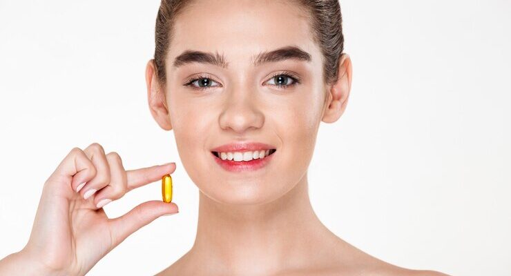 beauty-portrait-smiling-healthy-woman-with-dark-hair-holding-capsule-meds-vitamin-her-hand-posing_171337-685