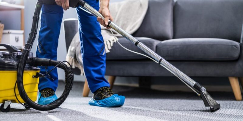 person-cleaning-carpet-with-vacuum-cleaner-picture-id1191080465-1024x683