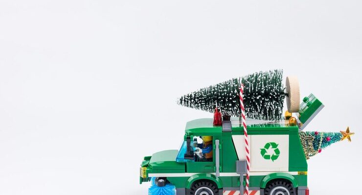 close-up-toy-truck-with-christmas-tree-against-white-background_1048944-20981363