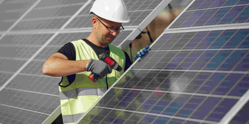 man-with-white-helmet-near-solar-panel (1)