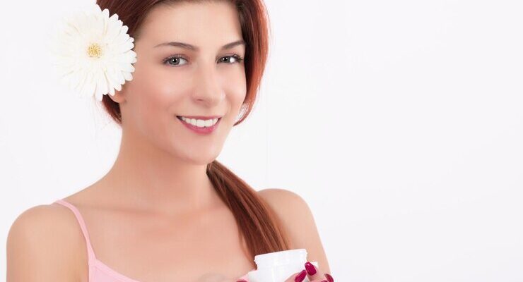 portrait-smiling-woman-wearing-flower-against-white-background_1048944-28845040