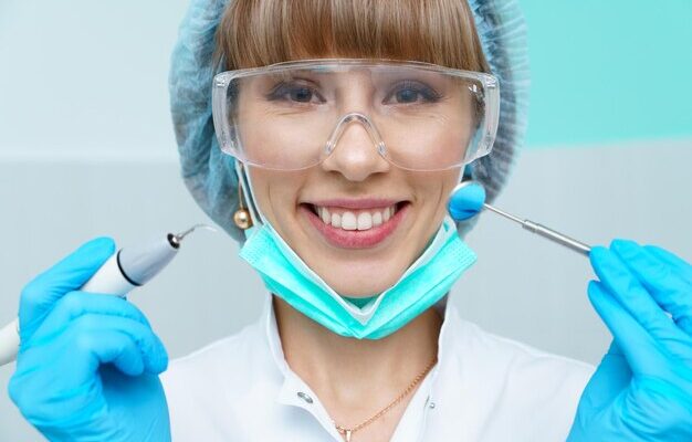 young-female-dentist-treating-patients-teeth-by-filling-cavity-dentist-works_1048944-6316658